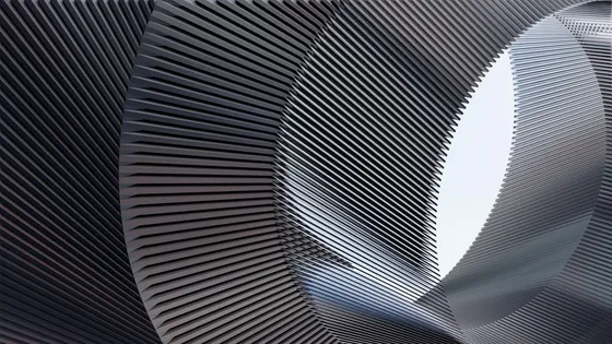 Closely spaced metal fins curving away from the viewer